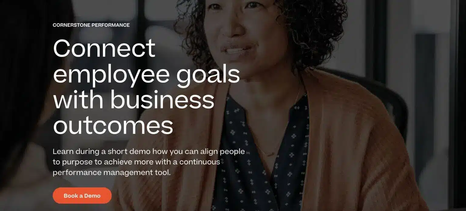 CORNERSTONE PERFORMANCE website: "Connect employee goals with business outcomes" above a "Book a Demo" button and a blurred image of people in a professional setting.
